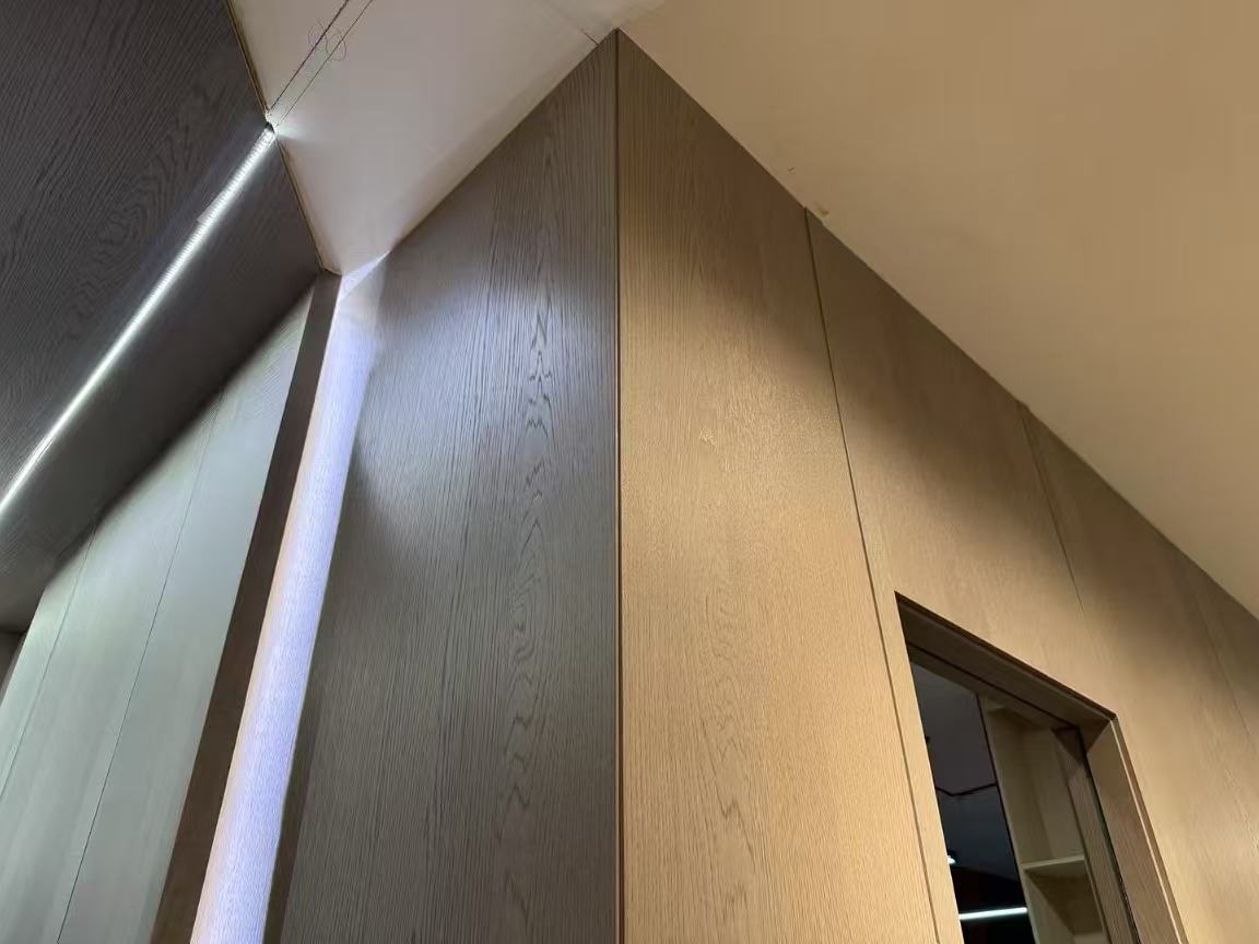 Mitred woodgrain wall panels around a corner and doorway